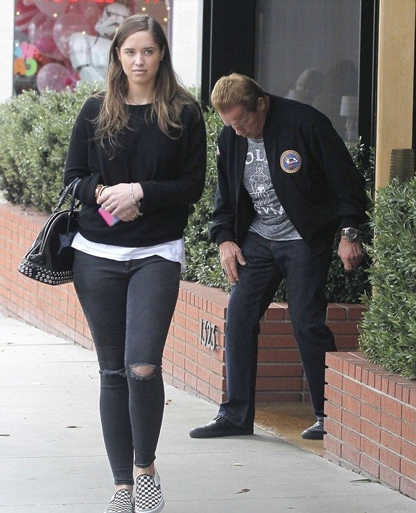 Christina Schwarzenegger with her father behind her back